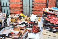 Old food containers outside by the trash