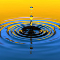 zoomed in water droplet hitting lake, blue and yellow