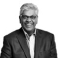 Black and white photo of Chandra Madramootoo in a suit coat and glasses