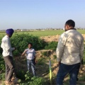Student speaking to two others on farm in India